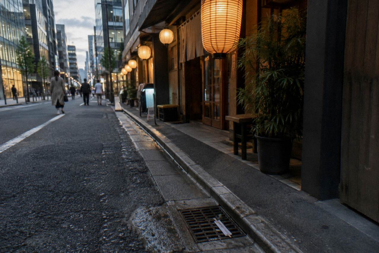 Evening light on a narrow Ginza side street with lanterns glowing above small restaurant entrances