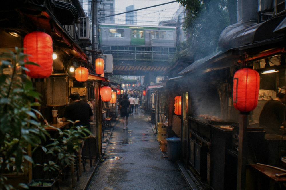 Smoky lantern-lit alley of Omoide Yokocho with narrow grill counters on both sides