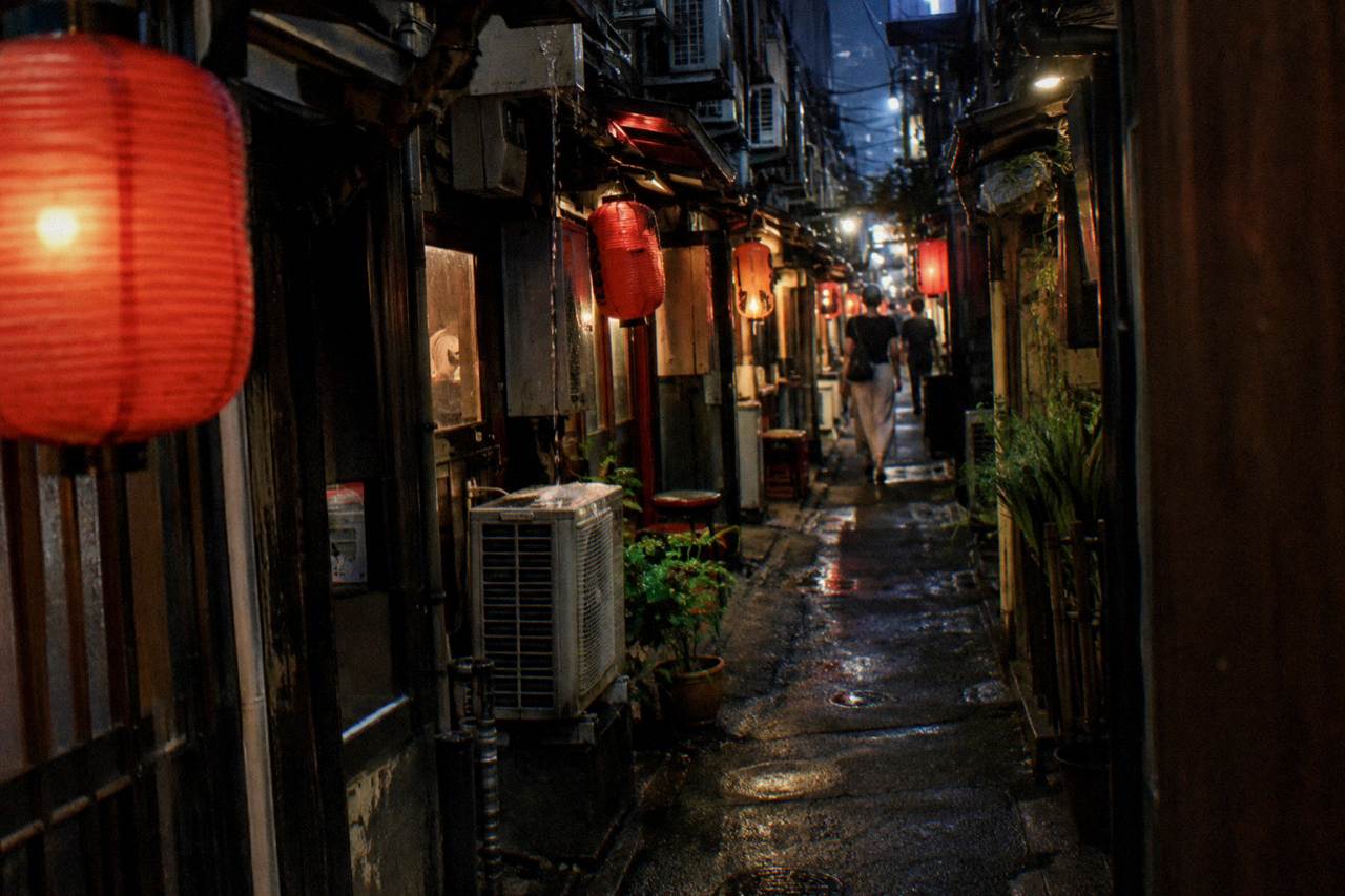 Narrow lantern-lit alley of tiny bars in Shinjuku at night