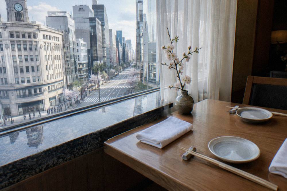 Empty set table at a small Japanese restaurant with chopsticks on rests before service