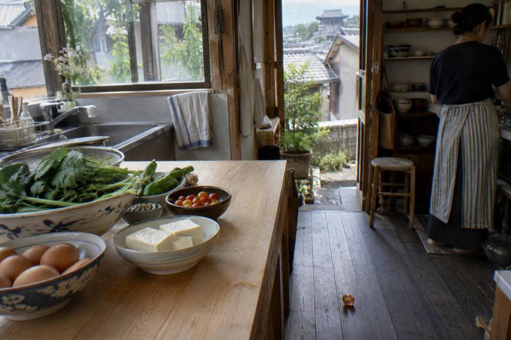 Fresh ingredients laid out on a wooden counter before a Japanese cooking session