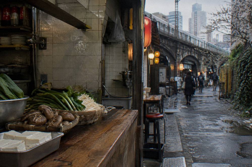 Fresh vegetables and plant-based ingredients laid out on a wooden cooking station