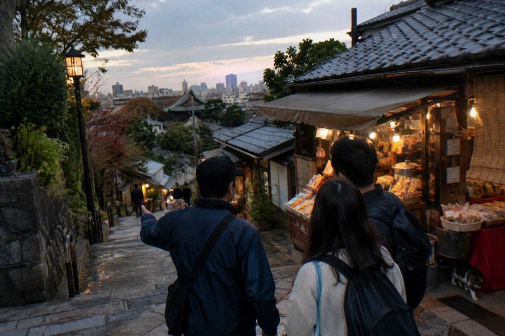 Guide leading a small group along a lantern-lit food street at dusk