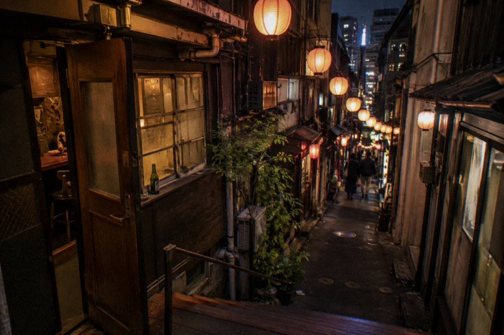 Narrow lanes of tiny glowing bars with lanterns strung overhead in Golden Gai